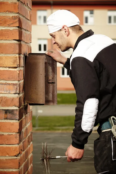 Professional chimney service technician at work
